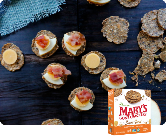 Mary’s Gone Crackers Super Seed Everything Crackers topped with apple, bacon and cheddar.
